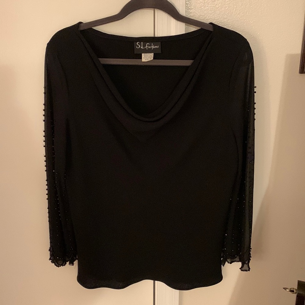 Women’s beaded, long sleeved, formal blouse in black.